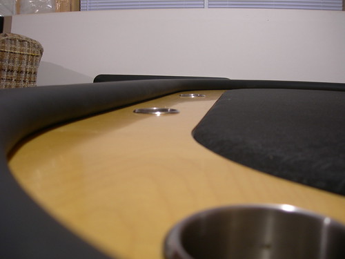 Close-up of hardwood raceway, stainless cup holders, and padded black rail